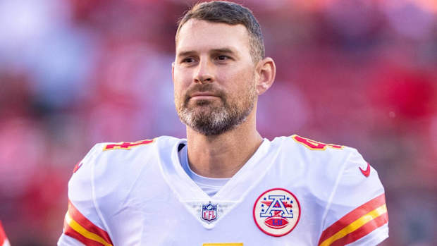 Chiefs quarterback Chad Henne looks on without a helmet before a game.